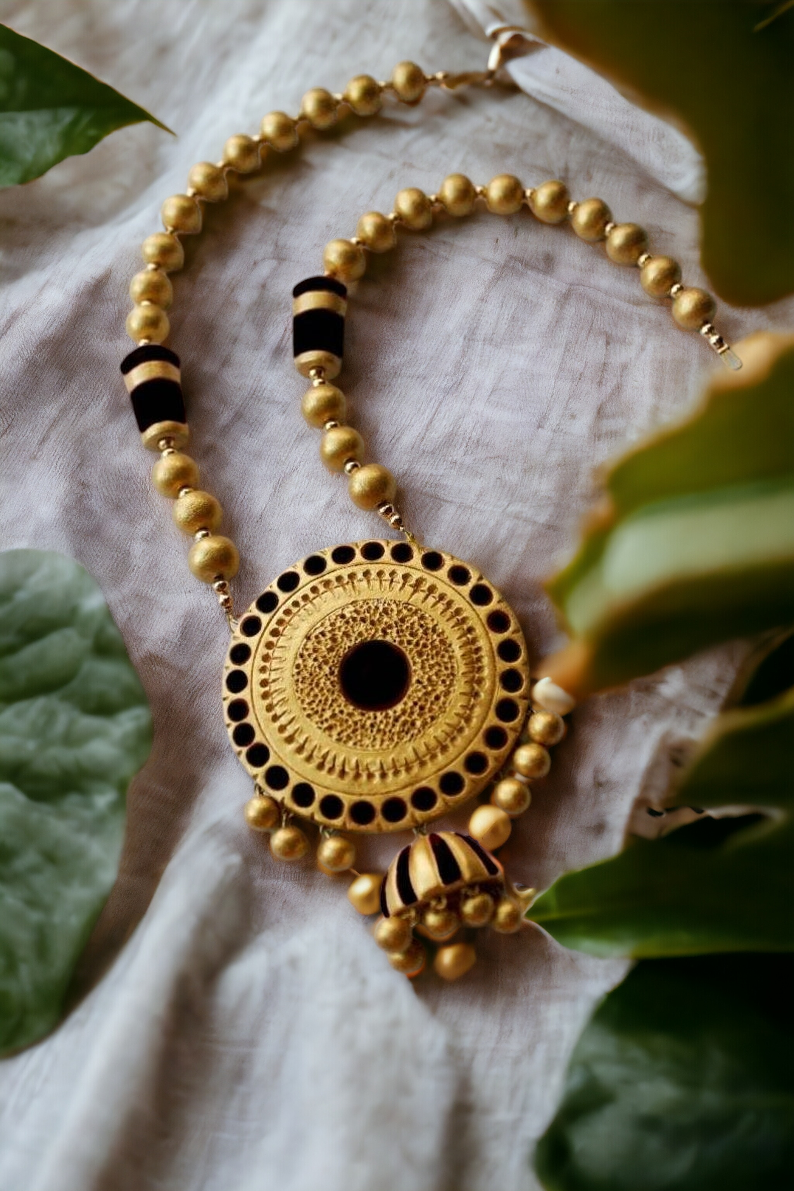 Aadhira terracotta jewelry necklace with intricate circular pendant and gold bead design from Anusangi Collections