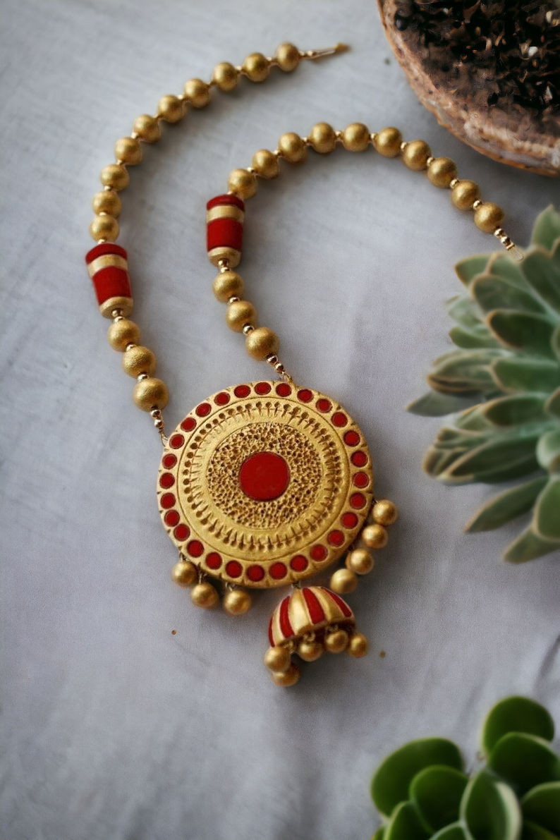 Aadhira terracotta jewelry necklace with red and gold round beads and intricate pendant design