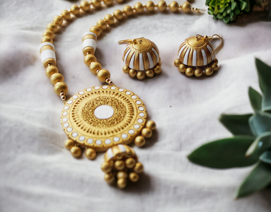 Aadhira terracotta jewelry set by Anusangi Collections featuring white and gold necklace with matching earrings