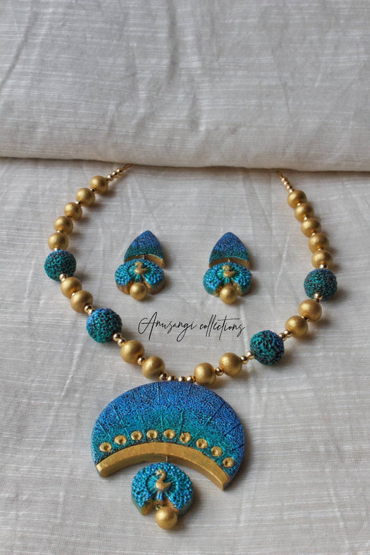 Nelamangala Mayura Terracotta Jewelry set by Anusangi Collections with blue and gold necklace and earrings