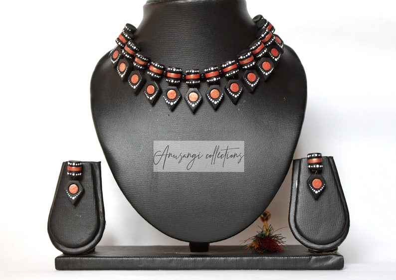Anusangi Collections black terracotta jewelry set with necklace and matching earrings on display