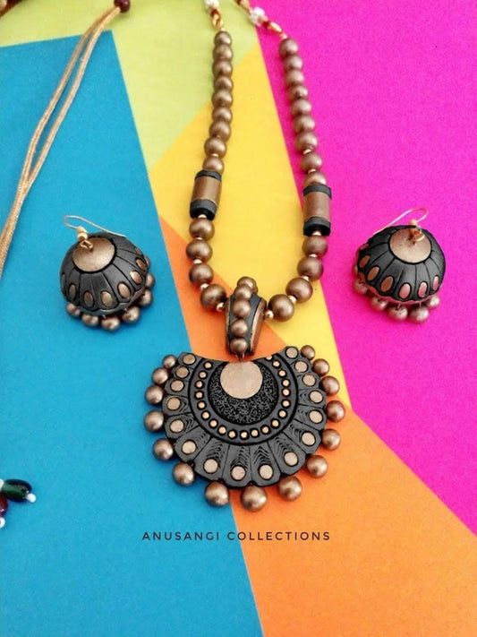 Handmade terracotta jewelry set from Anusangi Collections featuring black and brown necklace and matching earrings