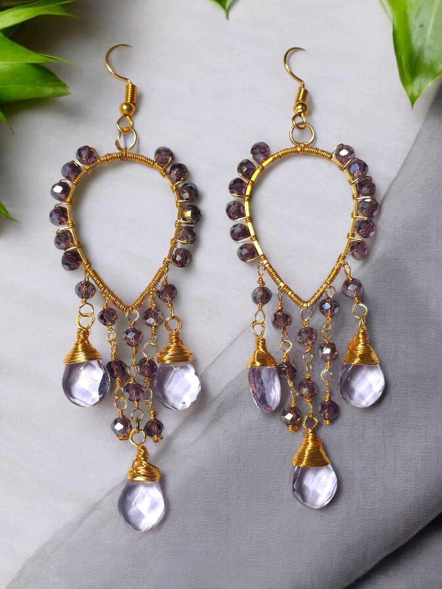 Anusangi Collections violet crystal earrings with gold wire and dangling beads in teardrop design