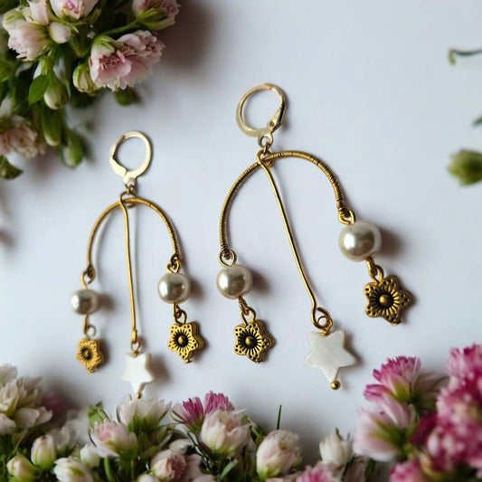 Anusangi Collections artisanal beaded earrings India with gold-tone floral charms and white star pendants