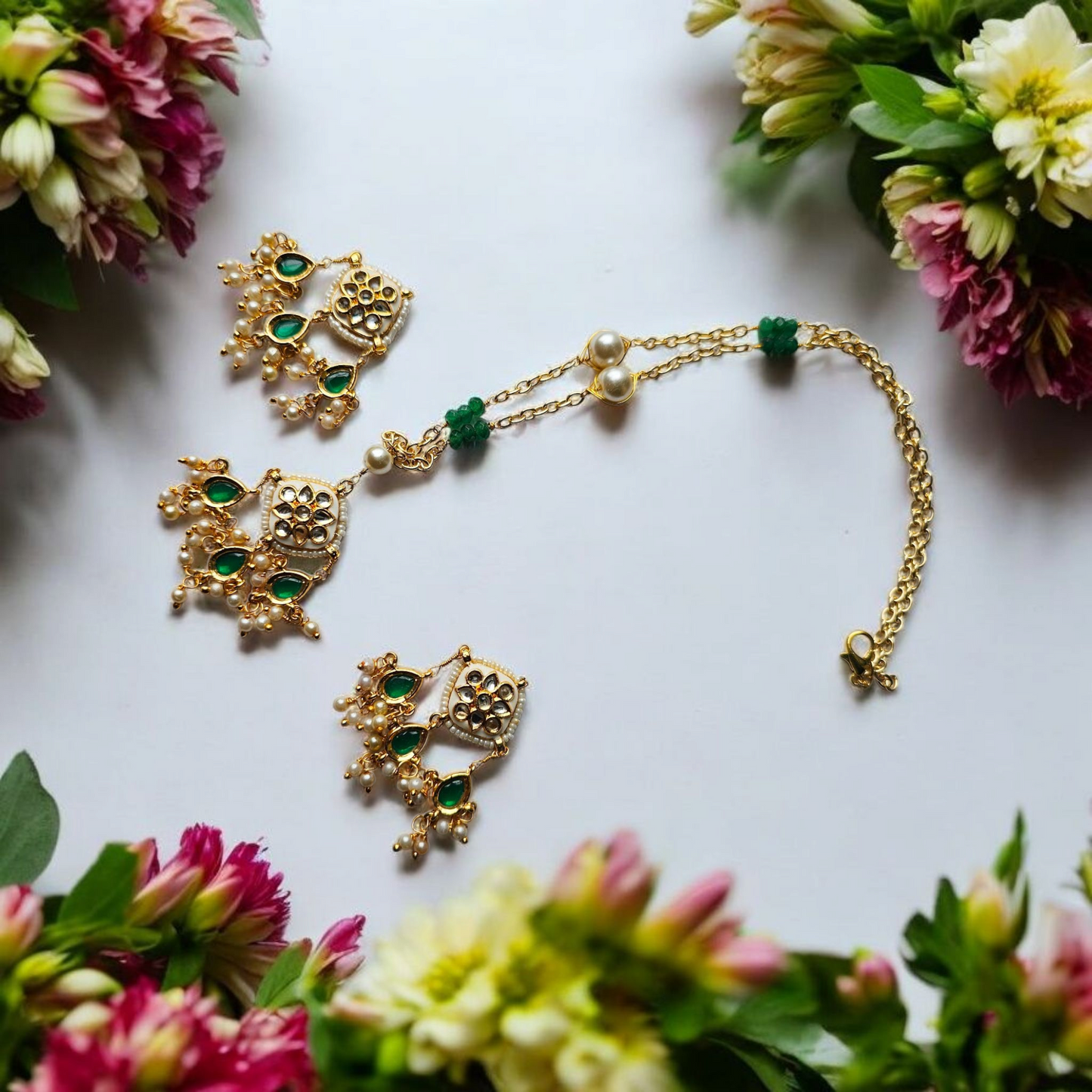 Anusangi Collections bani anti tarnish necklace and earrings with green beads and gold accents surrounded by flowers