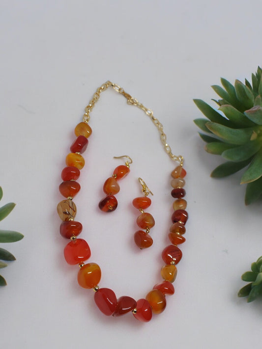 Beaded agate necklace and earrings set by Anusangi Collections with polished orange and red stones