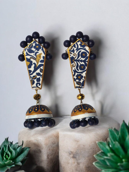 Blue and gold ethnic terracotta earrings with intricate floral patterns and bead accents from Anusangi Collections
