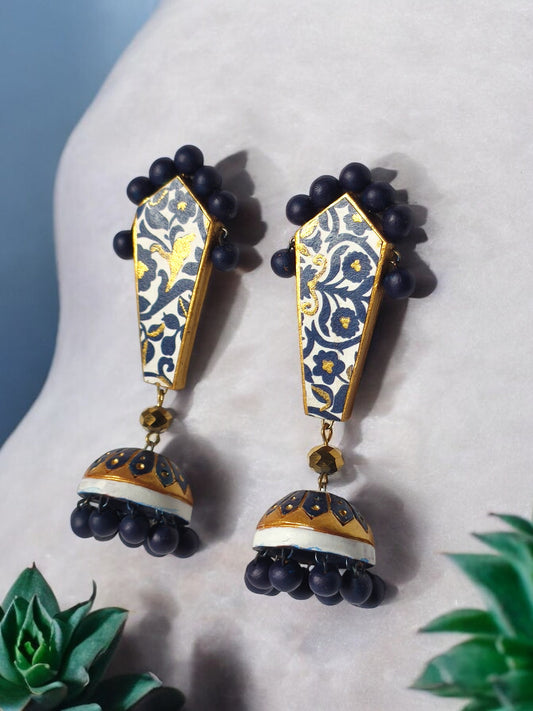 Blue and gold ethnic terracotta earrings by Anusangi Collections with floral patterns and bead details