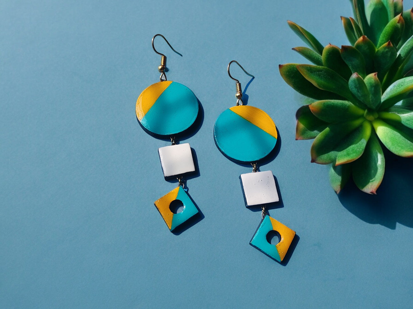 Colorful terracotta earrings with blue, yellow, and white geometric shapes from Anusangi Collections fancy terracotta jewelry