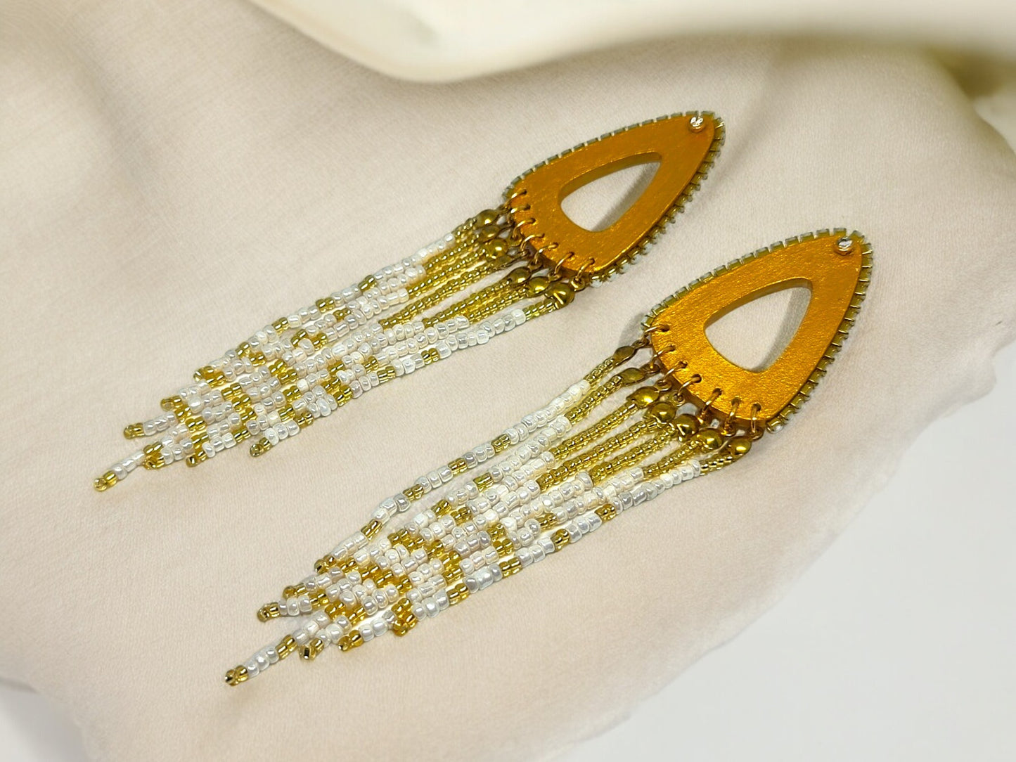 Anusangi Collections boho gold beaded earrings with white and gold beads and teardrop-shaped design