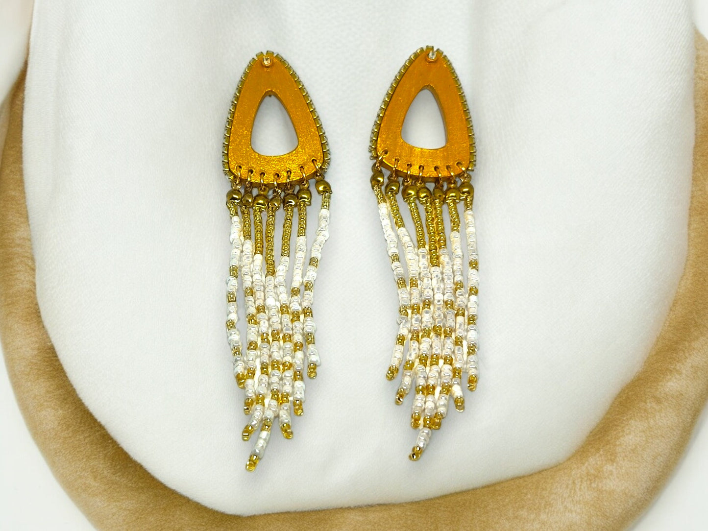 Boho gold beaded earrings from Anusangi Collections with white and gold beaded tassel design