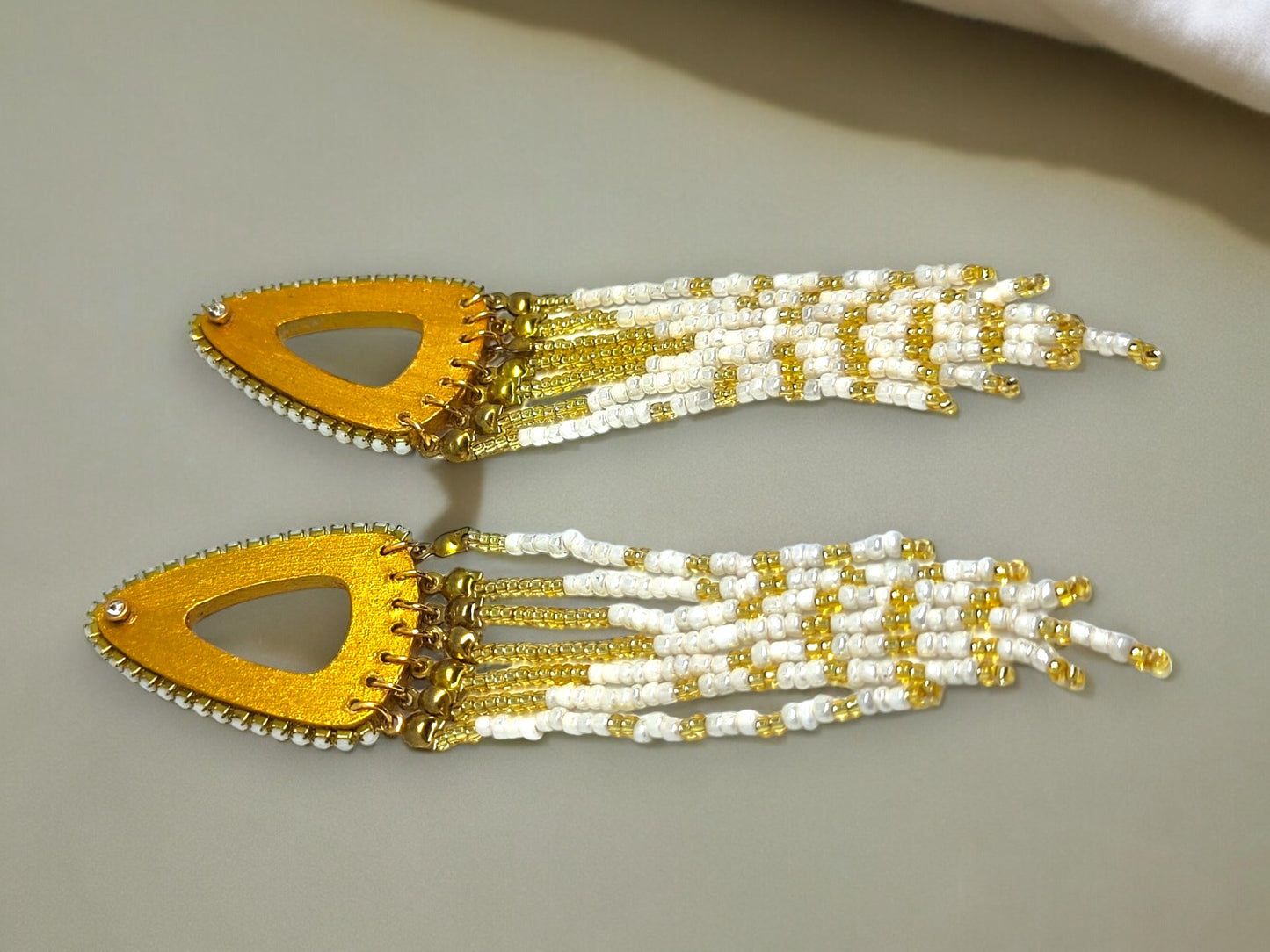 Boho gold beaded earrings with white and gold beads and triangular wooden accents