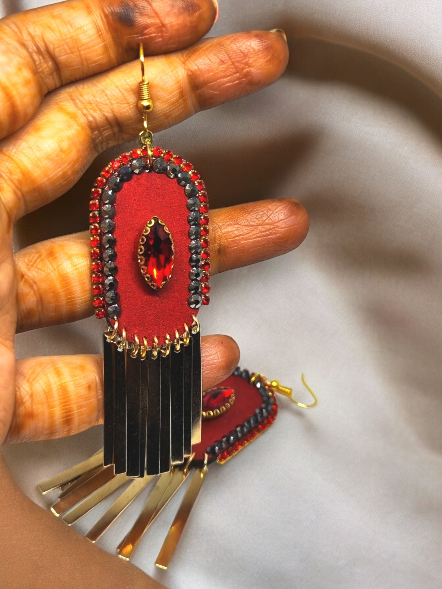 Boho red gold drop earrings with red beads, gold accents, and black fringe from Anusangi Collections