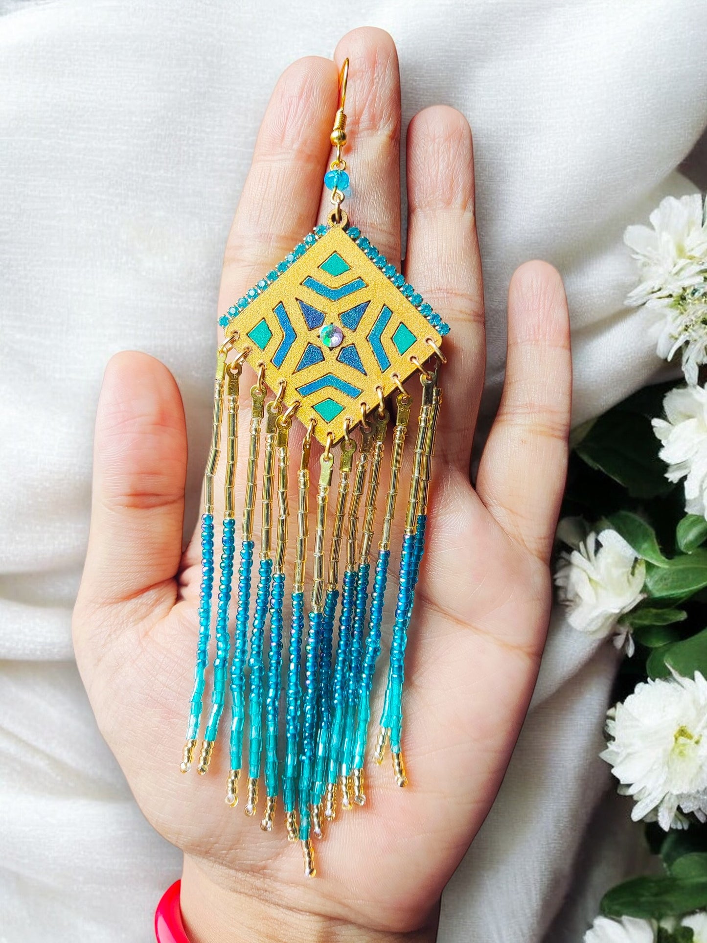 Boho statement beaded earrings with gold and blue geometric design and long dangling beads