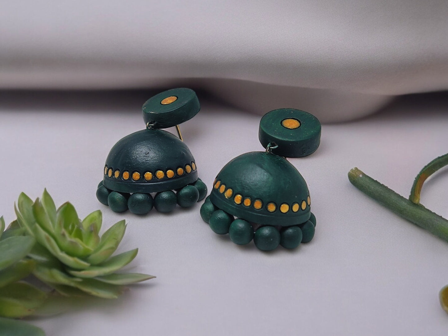 Bottle green terracotta jhumka earrings with yellow dot accents from Anusangi Collections