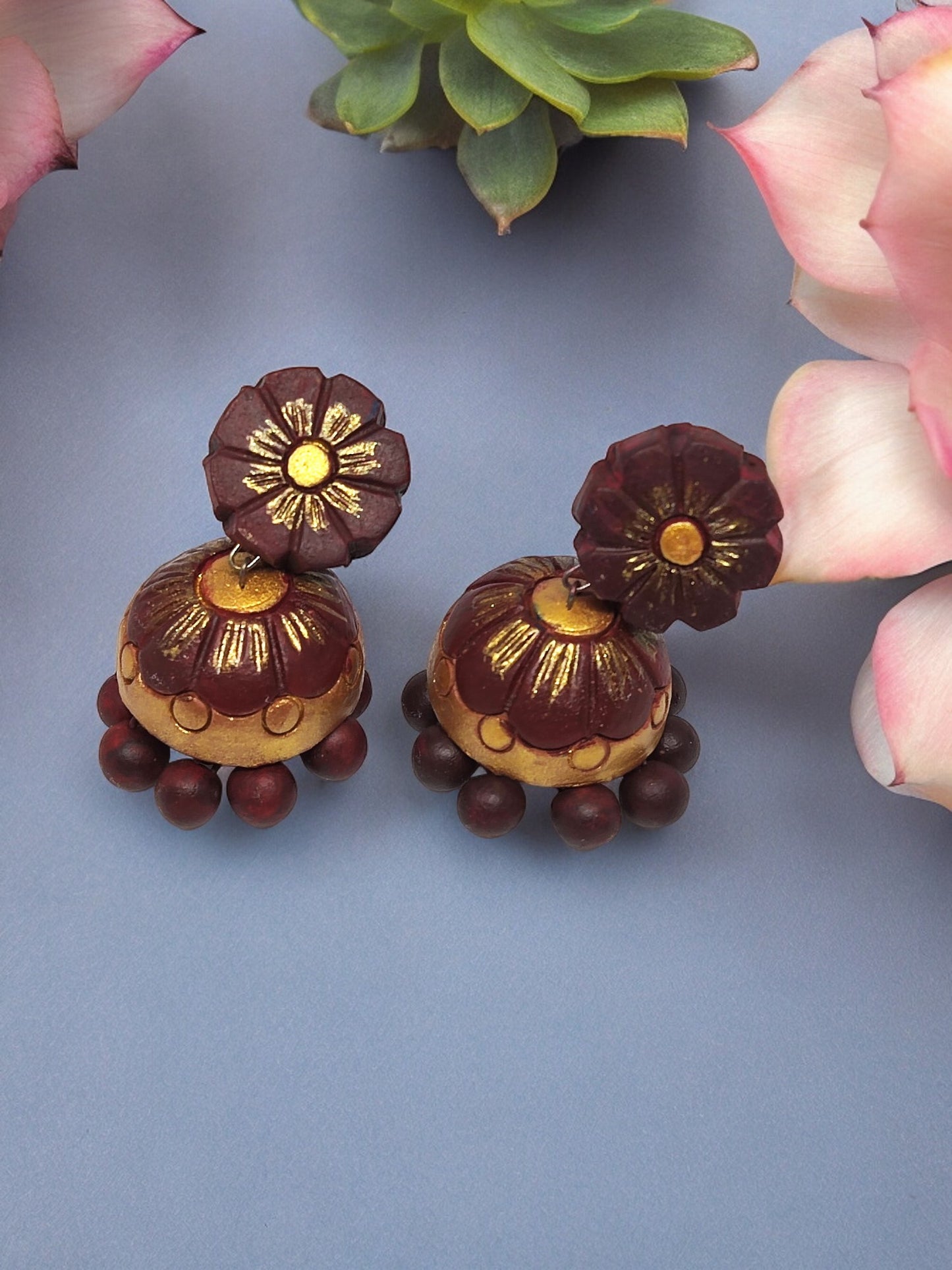 Anusangi Collections brown flower jhumka terracotta earrings with intricate gold and maroon detailing