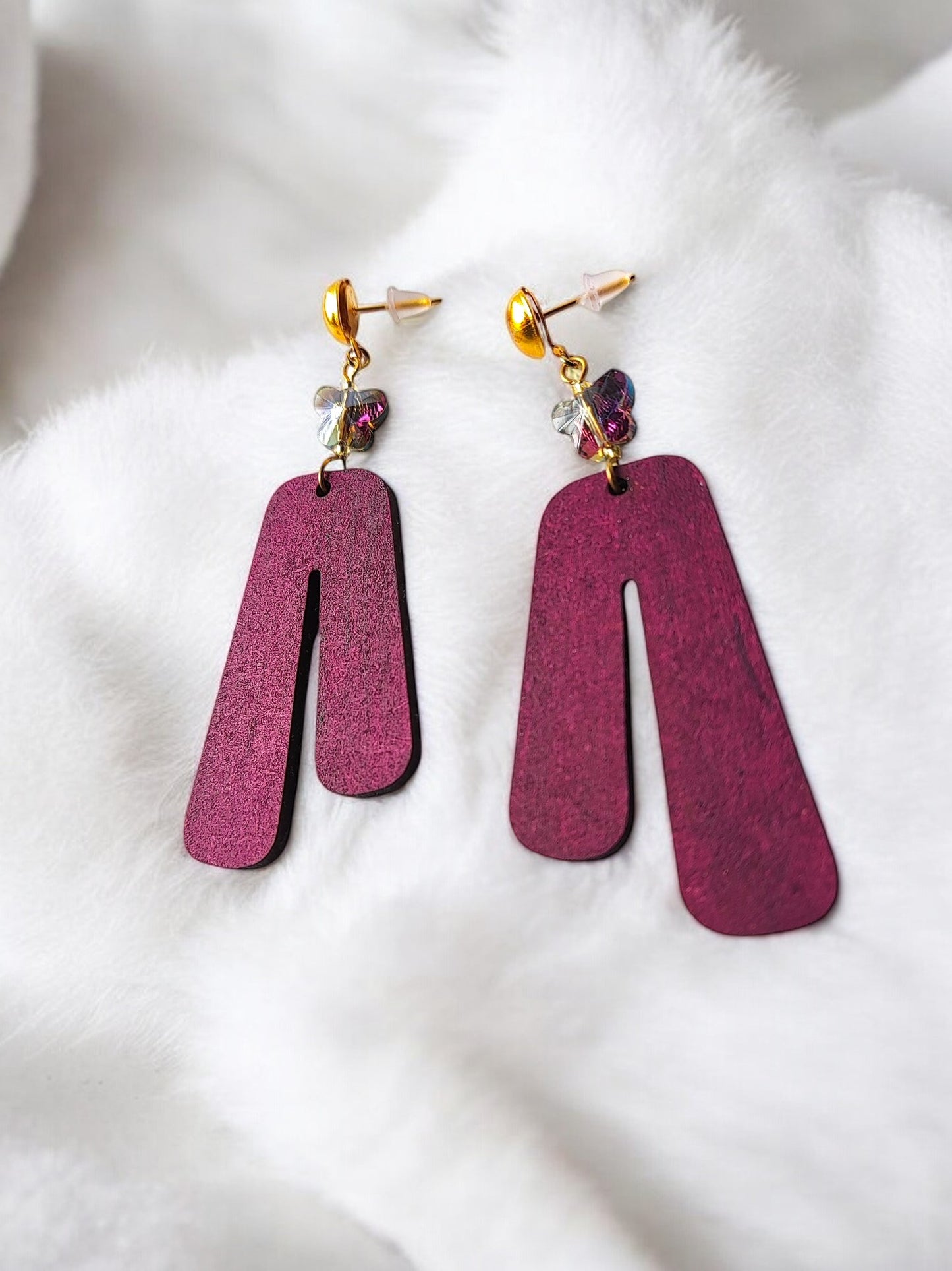 Anusangi Collections purple wooden earrings with gold studs and decorative beads on white fabric