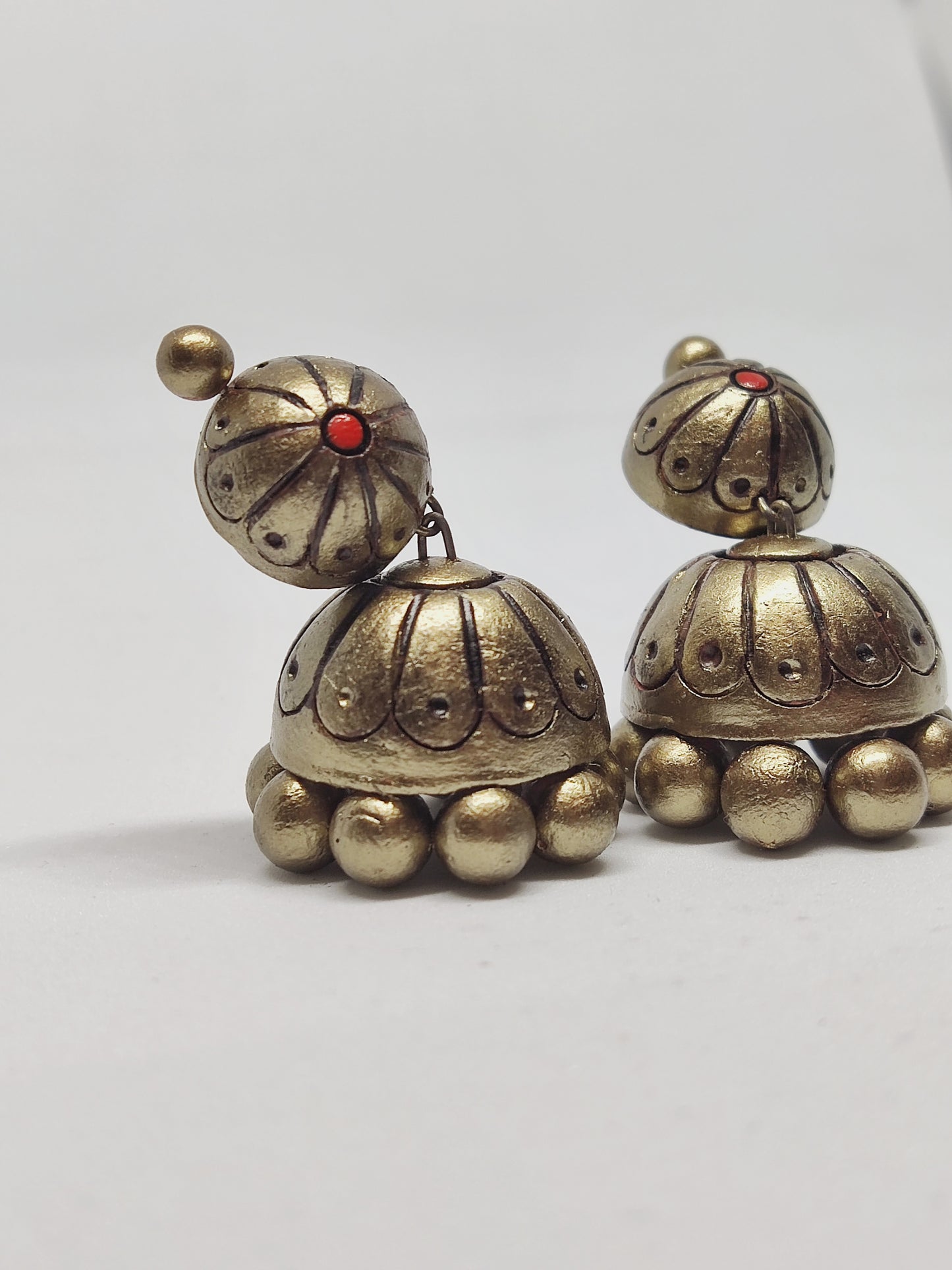 Antique gold tone terracotta earrings with intricate design and red accent buy Rachana Terracotta Jhumka online