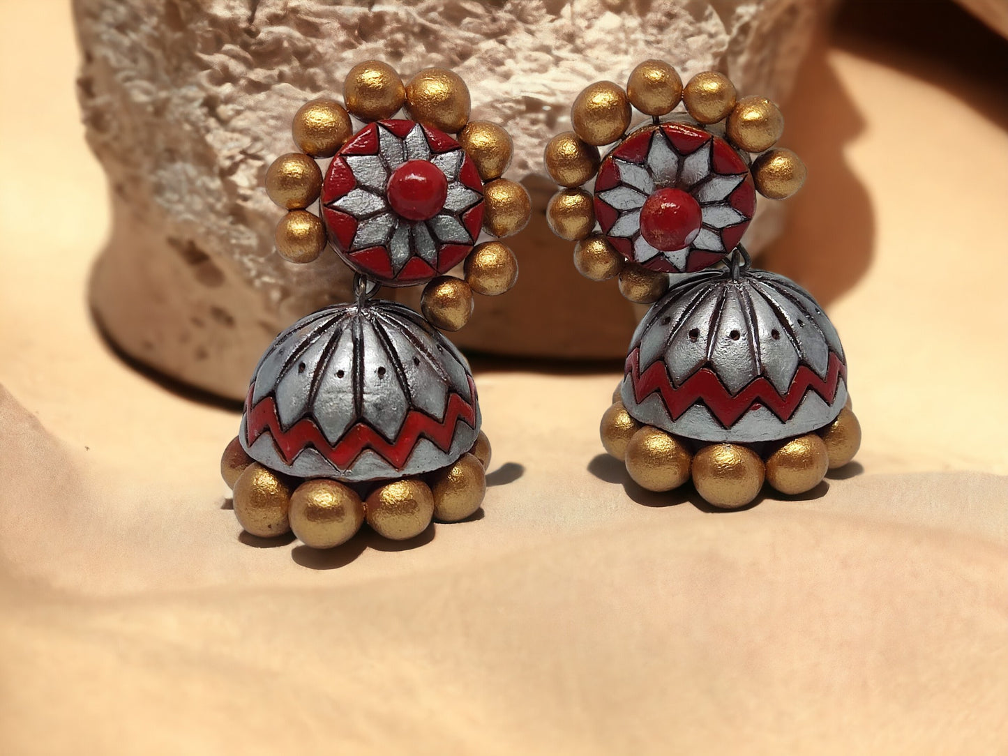Buy traditional Jhumka terracotta earrings in red and gold with floral and bead design from Anusangi Collections