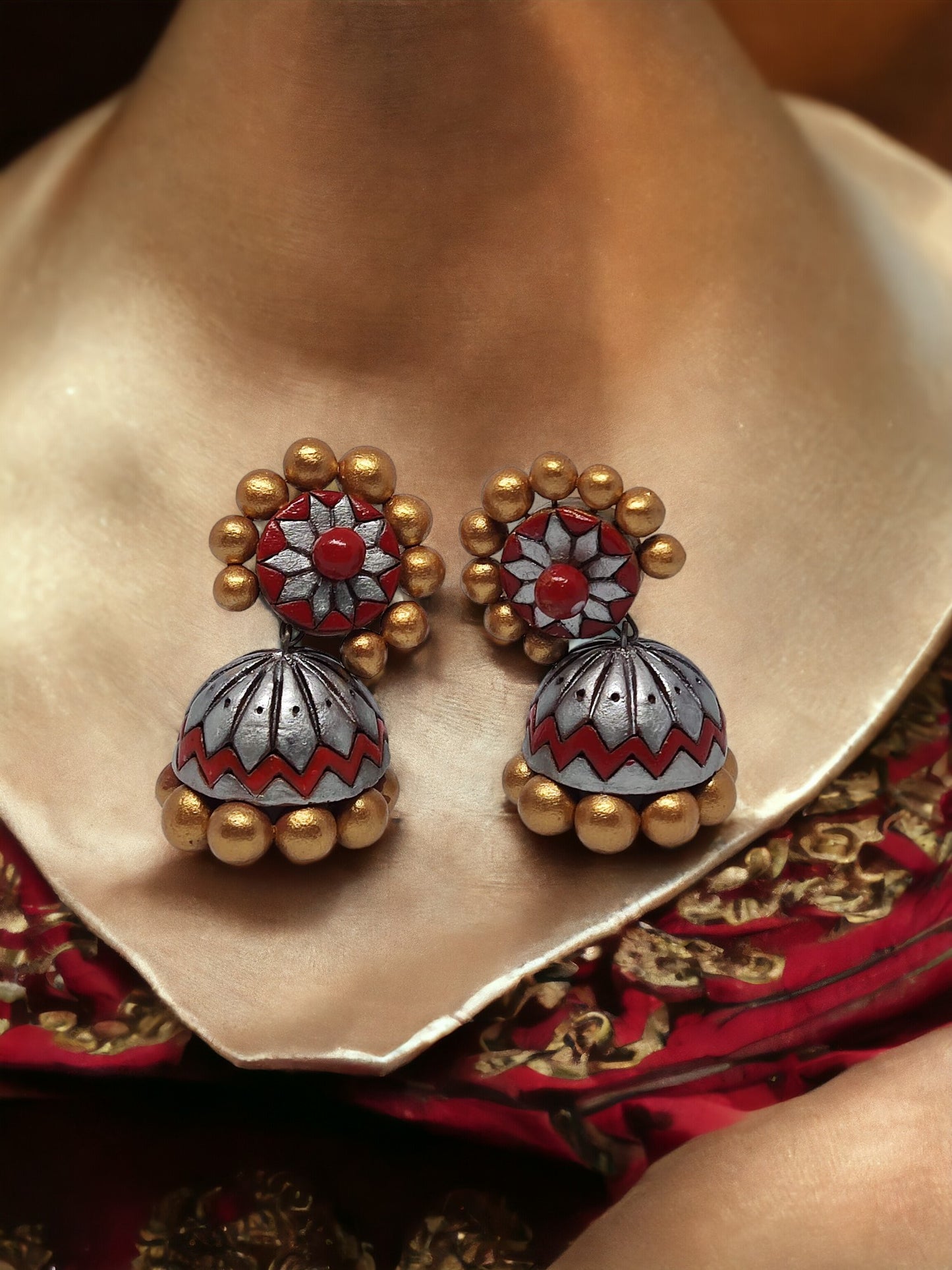 Buy traditional Jhumka terracotta earrings from Anusangi Collections featuring red and gold intricate design