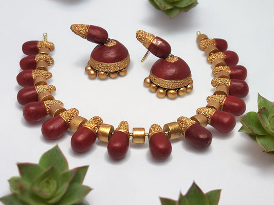 Classic terracotta necklace and earring set in deep red and gold from Anusangi Collections