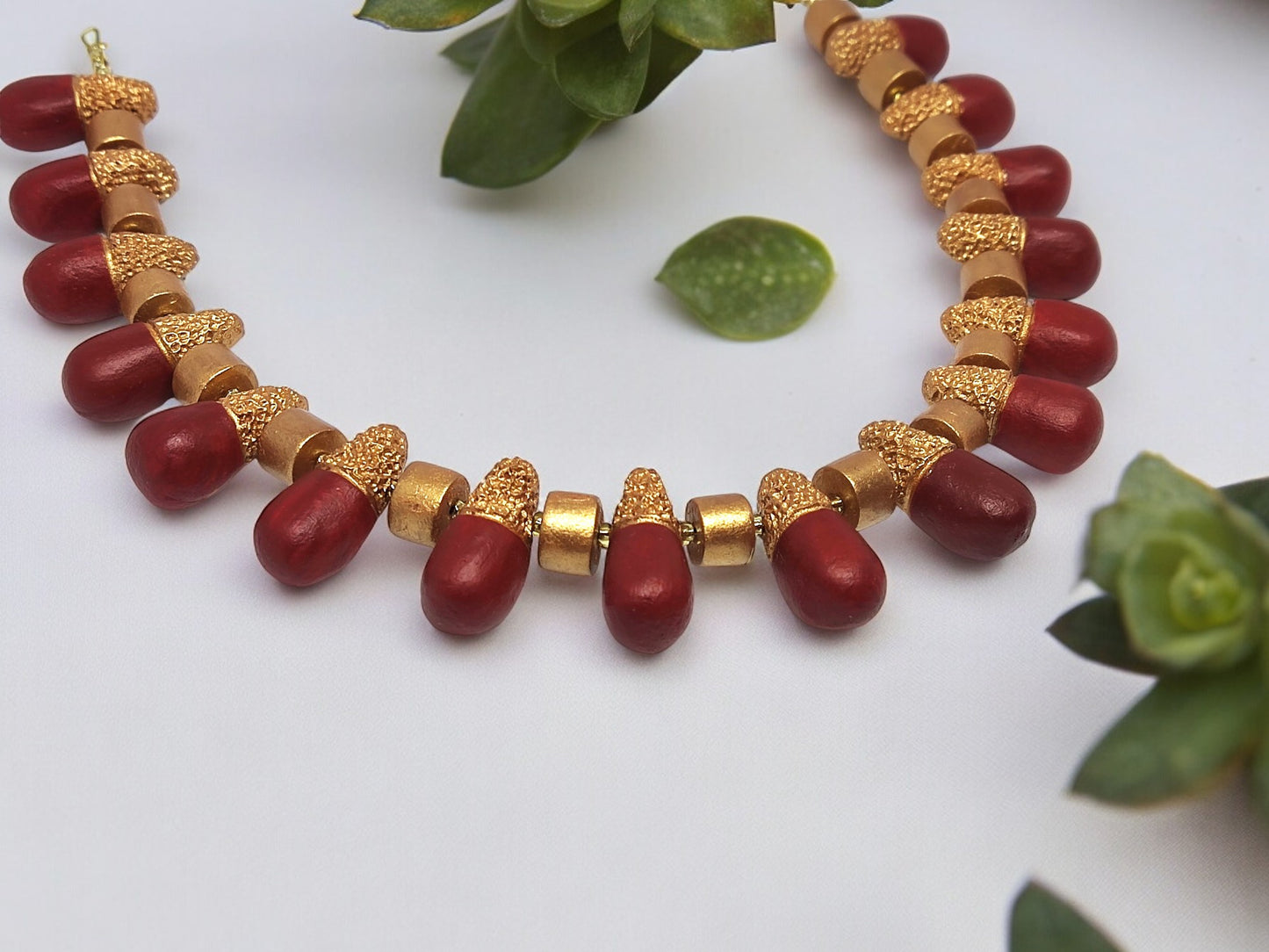 Classic terracotta necklace and earring set with red and gold beads from Anusangi Collections