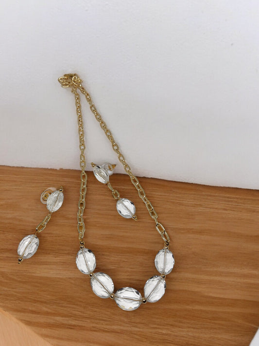 Anusangi Collections crystal clear necklace earring set with gold chain and large clear beads