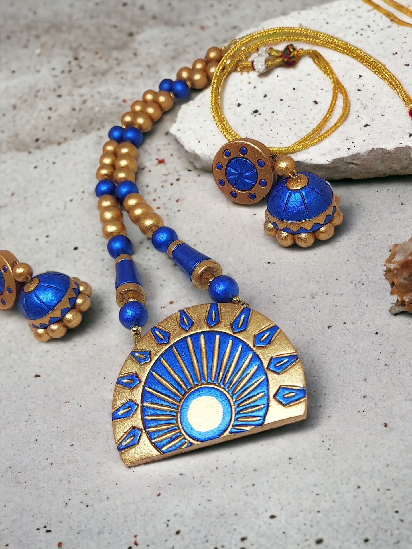 Dark blue terracotta jewelry set with gold accents including necklace and earrings from Anusangi Collections