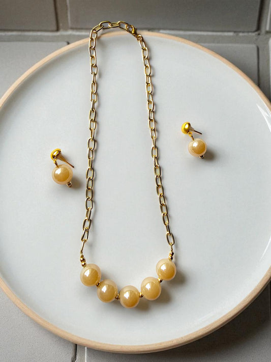 Elegant glass pearl jewelry for women with a gold chain necklace and matching earrings