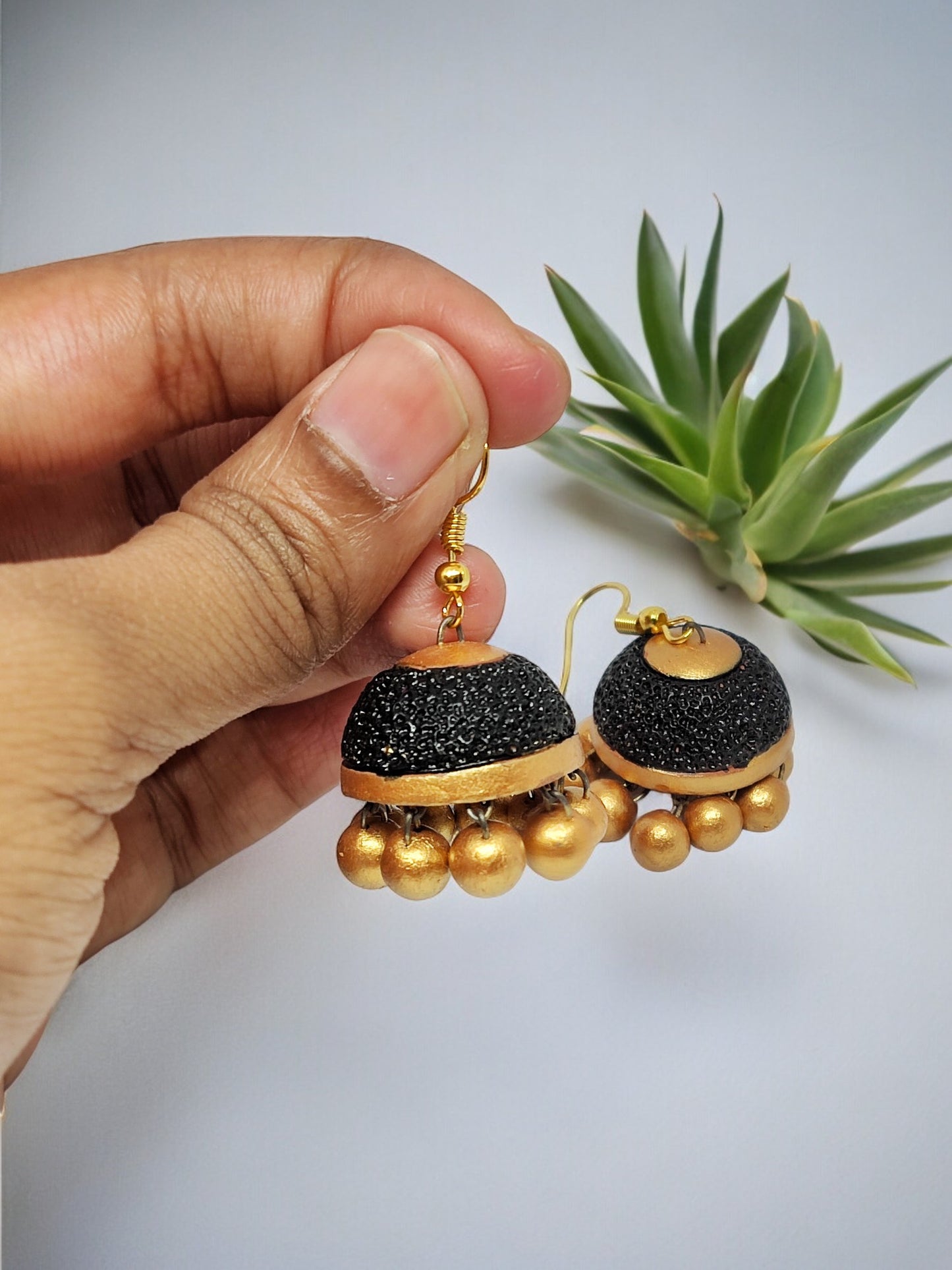 Ethnic jhumka earrings for women in black and gold terracotta design by Anusangi Collections