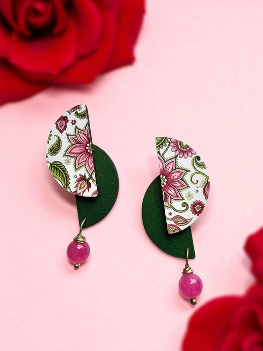 Floral pink wooden earrings with decorative patterns and green accents, perfect for stylish outfits