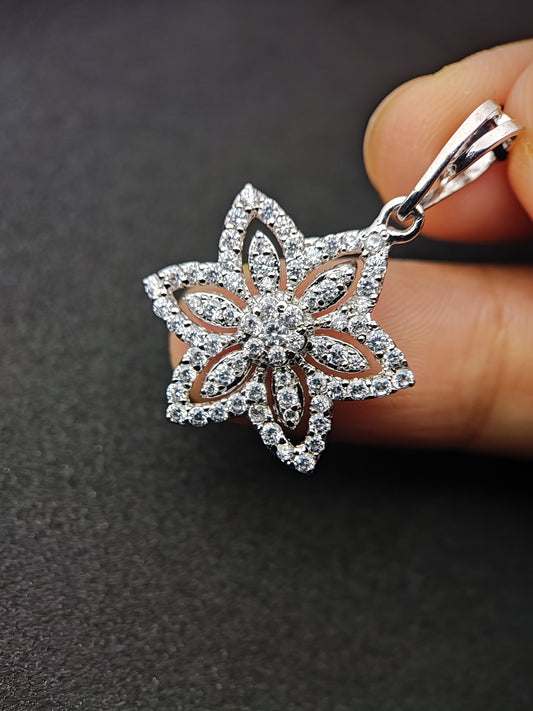 Anusangi Collections floral sterling silver necklace pendant held by hand with intricate flower design