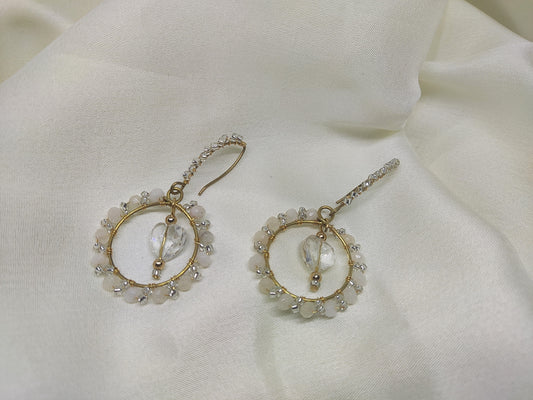 Anusangi Collections white wire wrap earrings with delicate bead and crystal design on white fabric