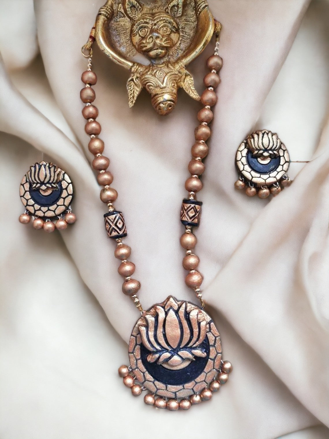 Anusangi Collections terracotta jewelry set featuring a golden lotus necklace for women with matching earrings