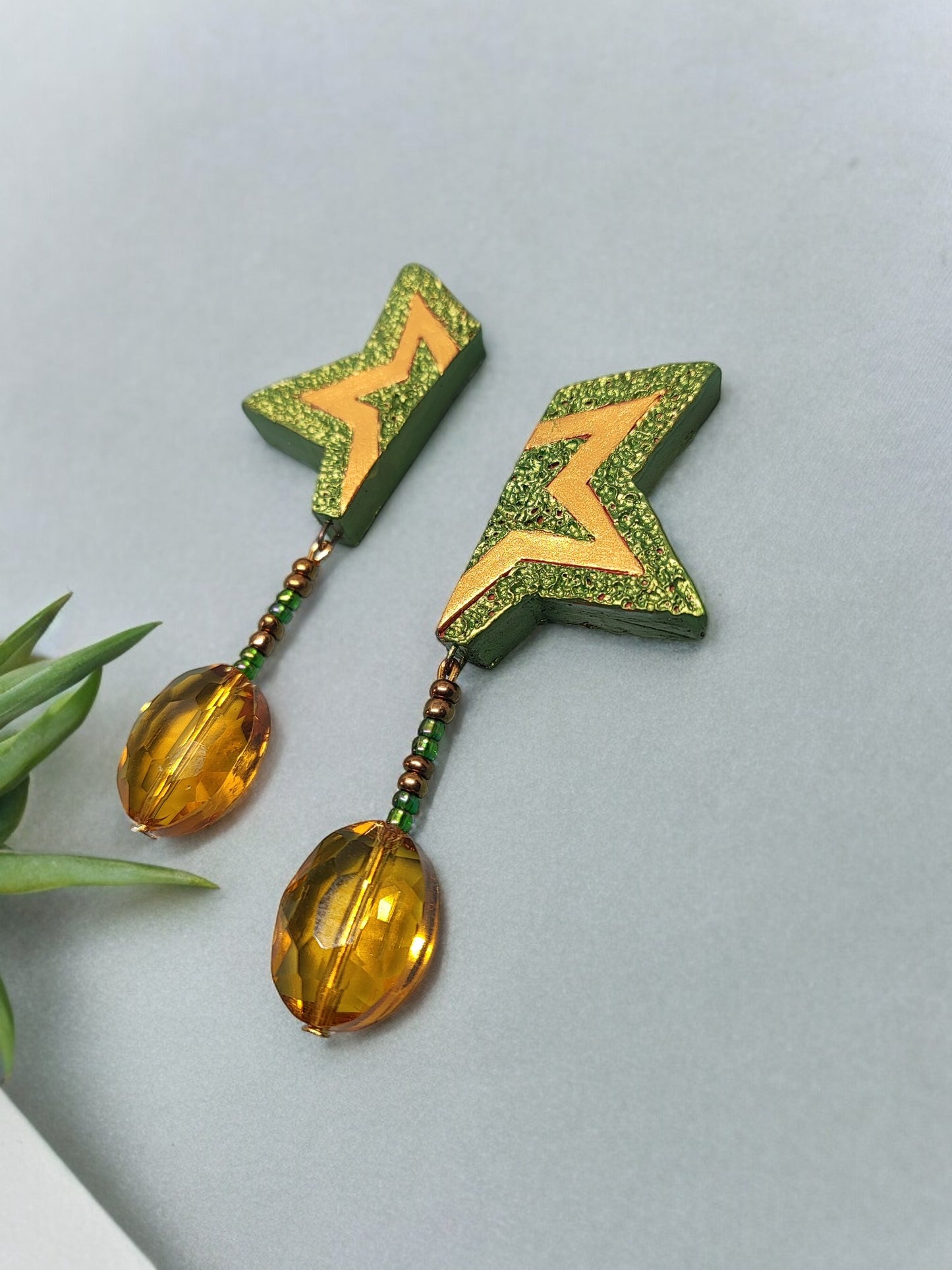 Anusangi Collections green terracotta earrings with star design and amber bead dangles
