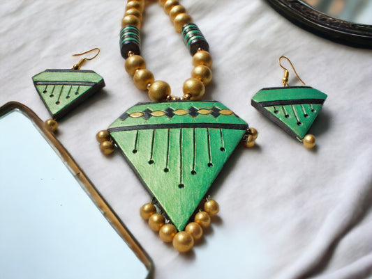 Green terracotta necklace and earring set from Anusangi Collections with gold bead accents