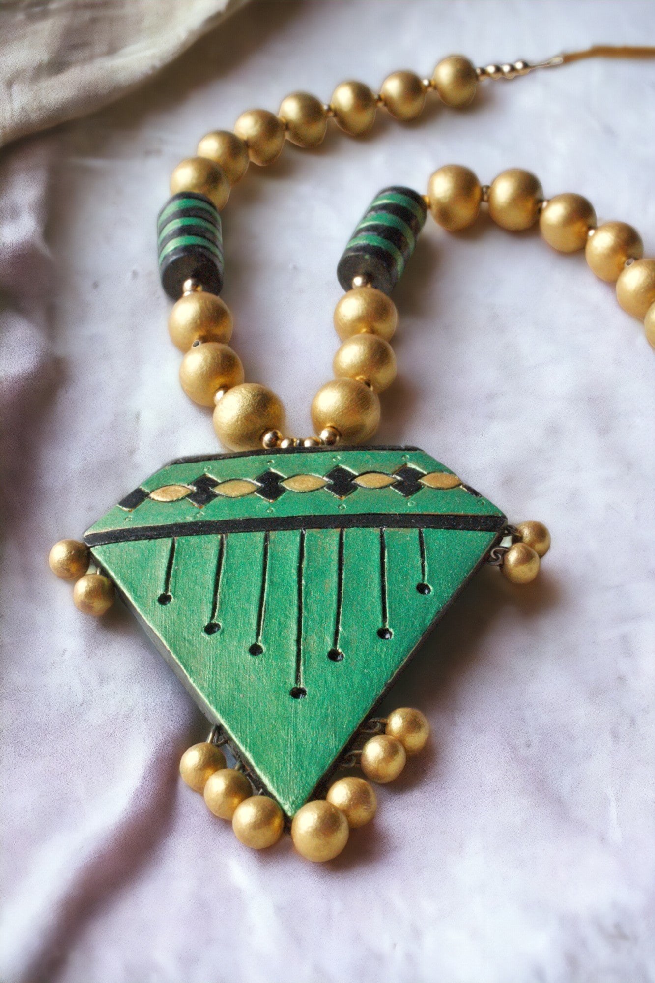 Green terracotta necklace and earring set with gold beads from Anusangi Collections