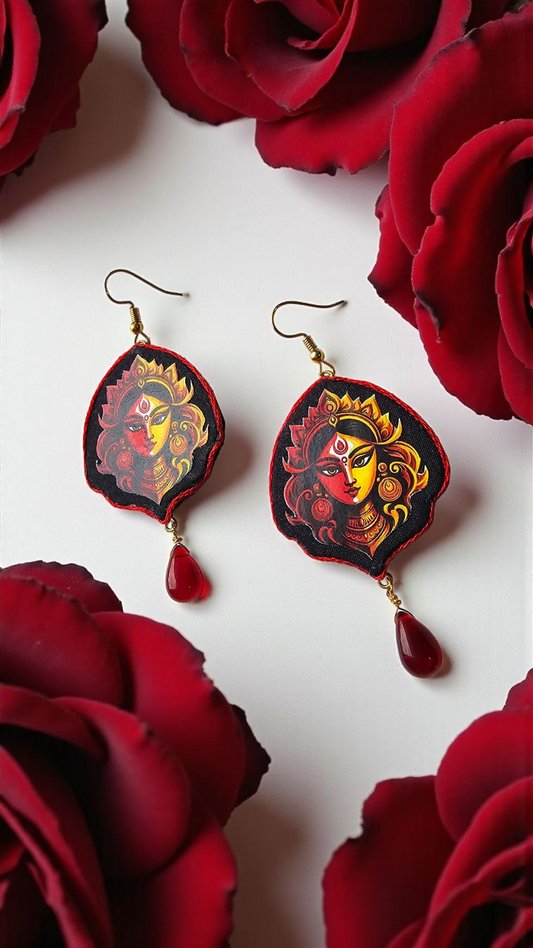 Hand-painted Durga face earrings with red drop embellishments, surrounded by red roses