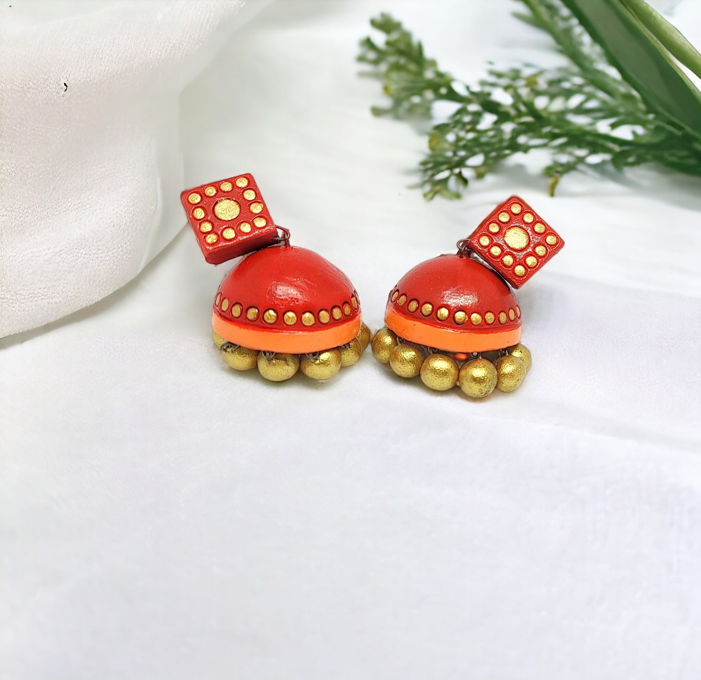 Anusangi Collections handcrafted terracotta jhumkas in red with golden bead detailing