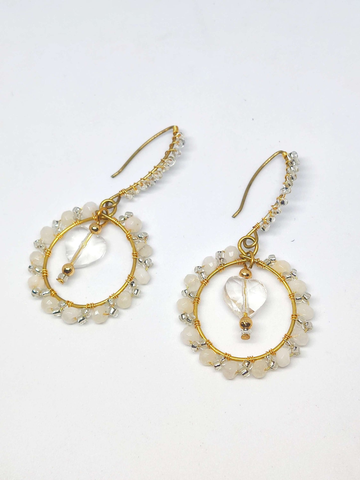 Handmade green wire wrap earrings with white beads and heart-shaped charm from Anusangi Collections