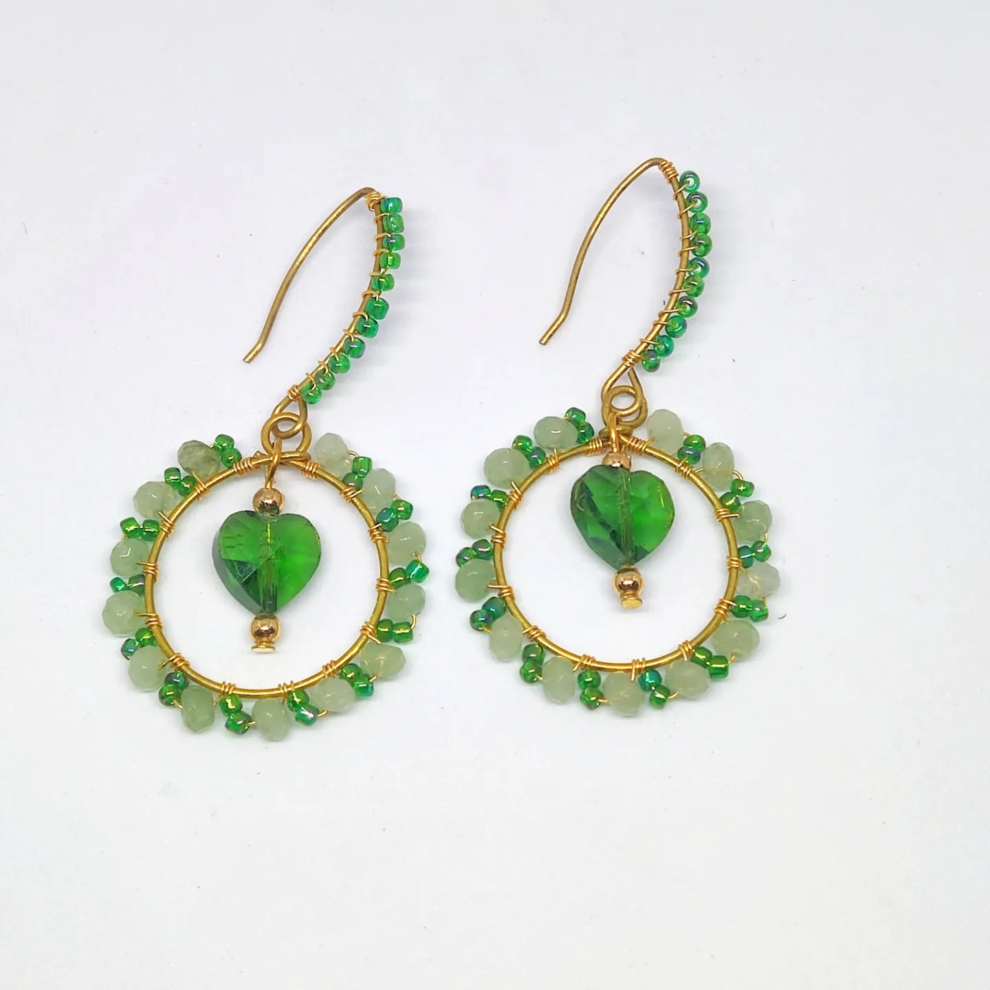 Handmade green wire wrap earrings with heart-shaped beads and gold-tone hooks from Anusangi Collections