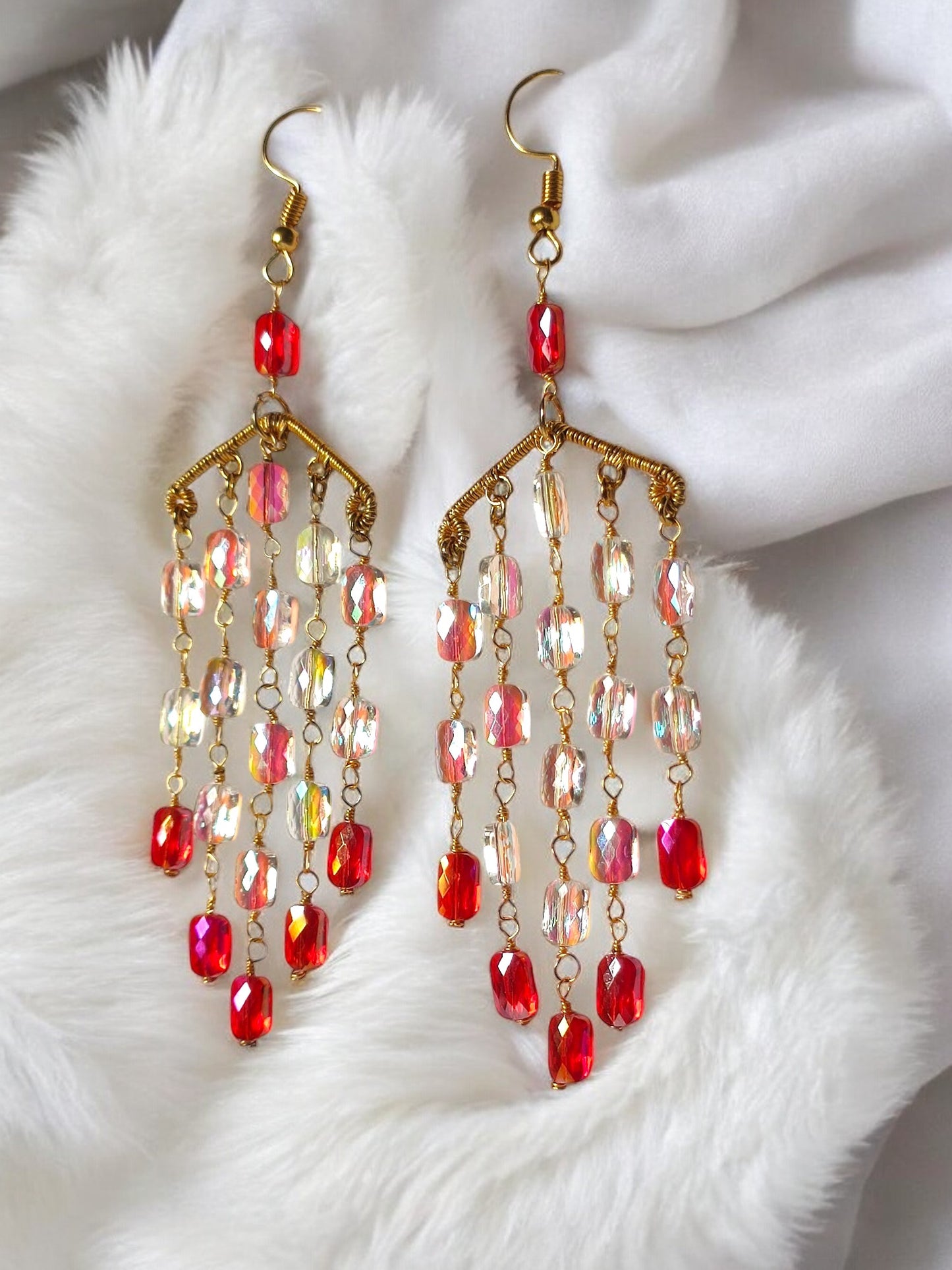 Handmade long dangle earrings from Anusangi Collections featuring red and iridescent beads with gold-tone chains