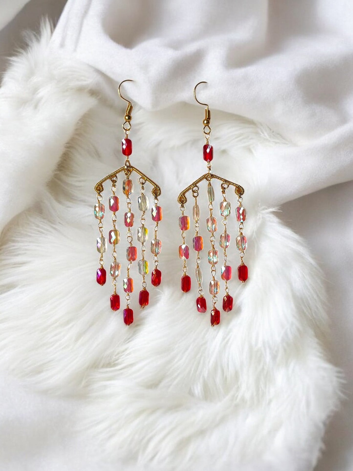 Anusangi Collections handmade long dangle earrings with red and gold beaded design on white fabric