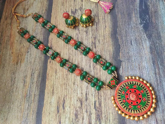 Handmade Sudarshan Chakra Terracotta jewelry set with green and red beads and matching earrings by Anusangi Collections