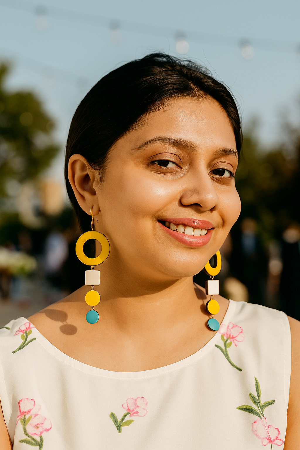 Woman wearing colorful handmade terracotta earrings from Anusangi Collections with yellow and blue accents
