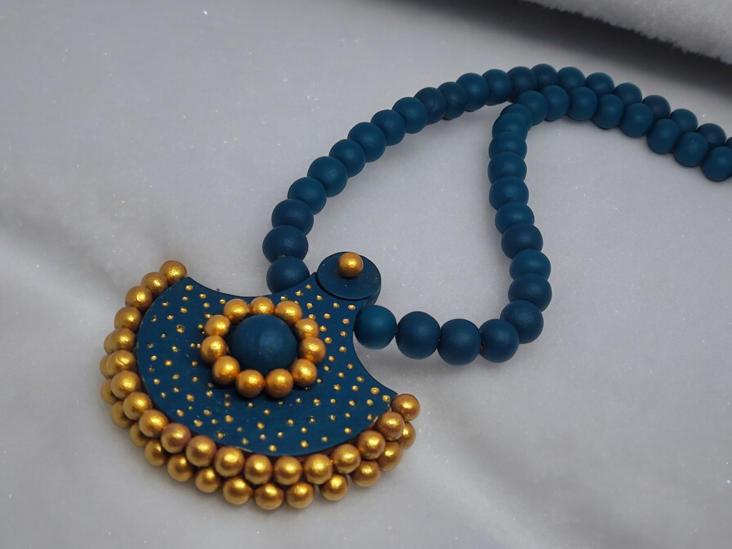 Handmade terracotta necklace and earrings in blue and gold beads from Anusangi Collections