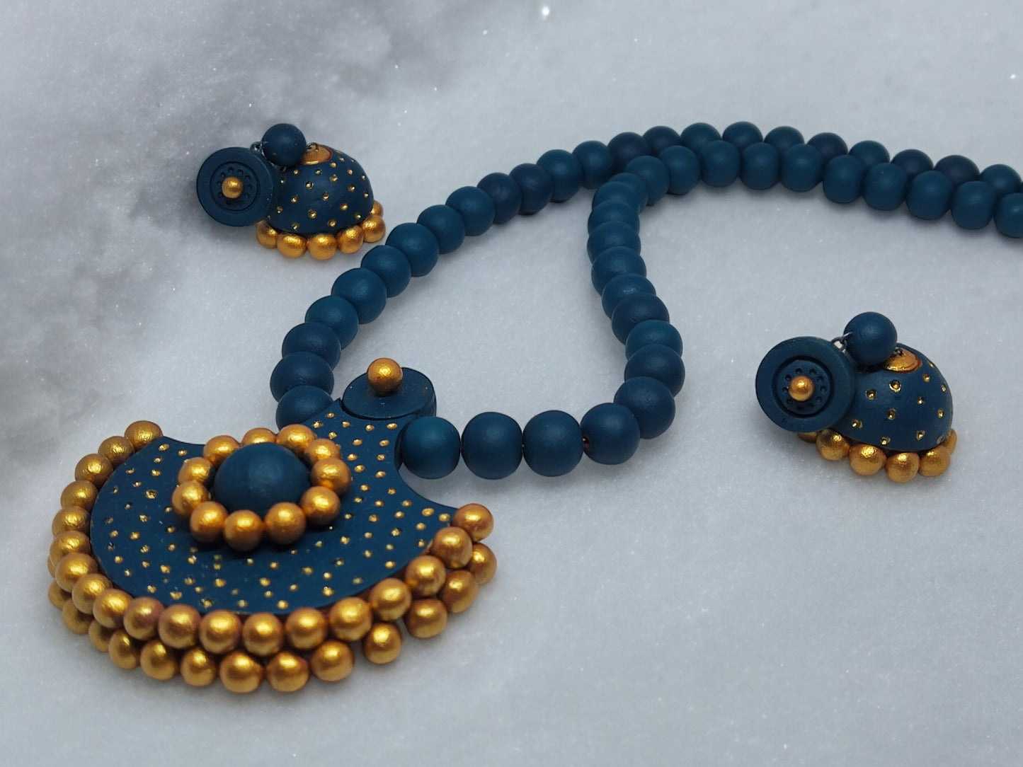 Anusangi Collections handmade terracotta necklace and earrings set in navy blue and gold beads