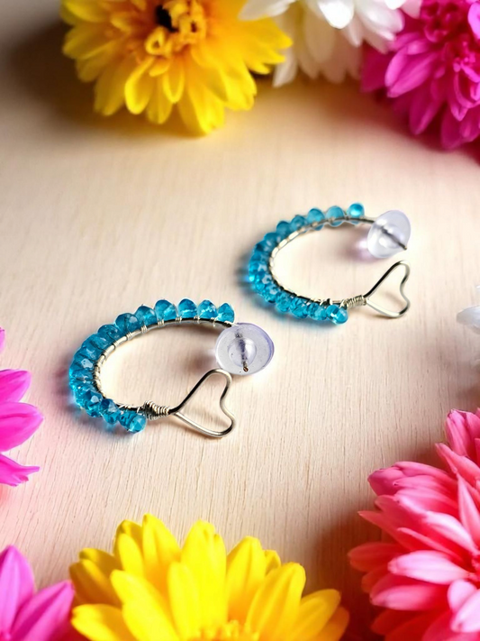 Anusangi Collections Heart Hoop Wire wrap Earring with blue beads and heart-shaped wire on light wood surface
