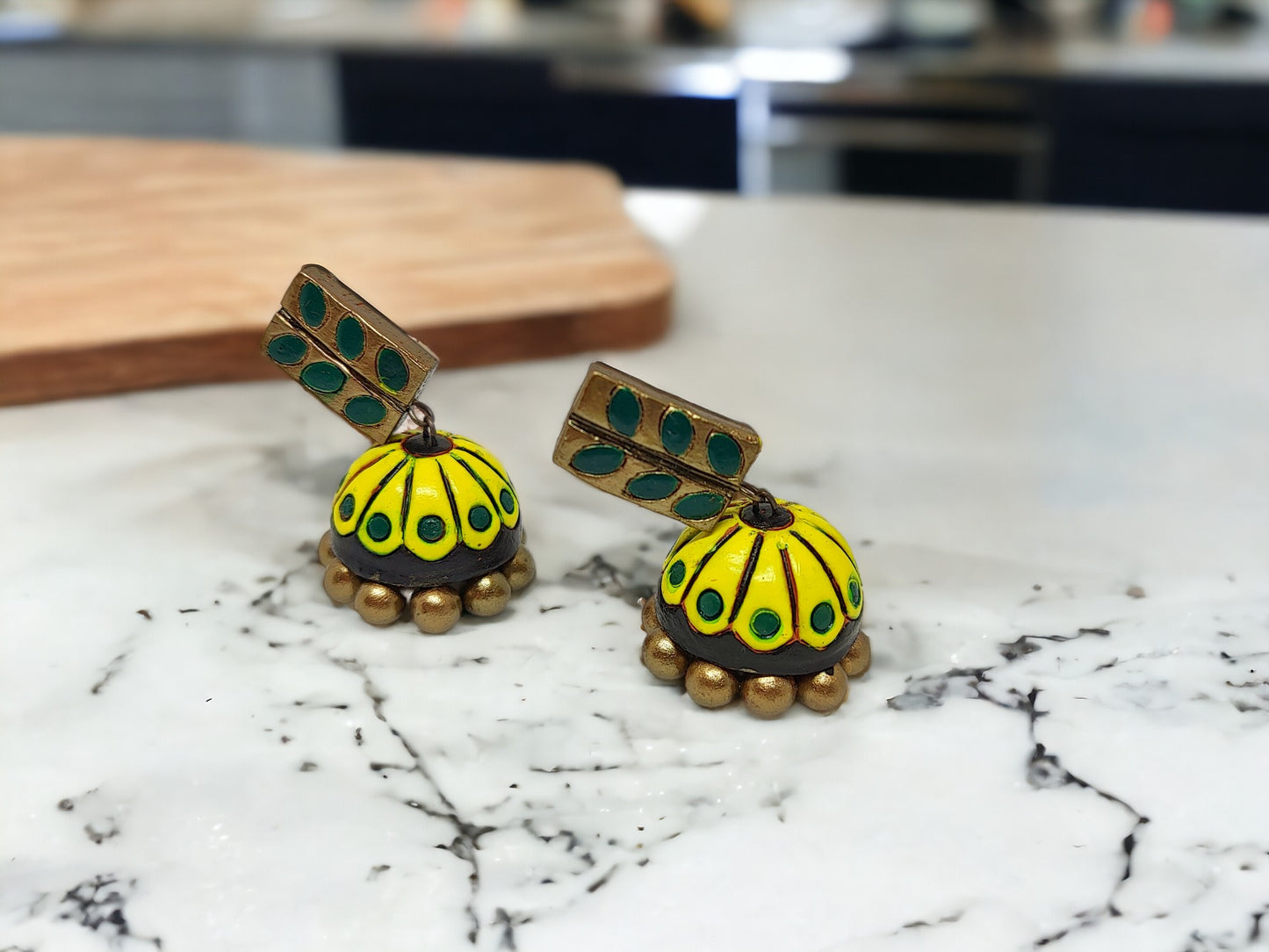 Anusangi Collections Indrani Jhumka terracotta earring for women in yellow with green leaf design