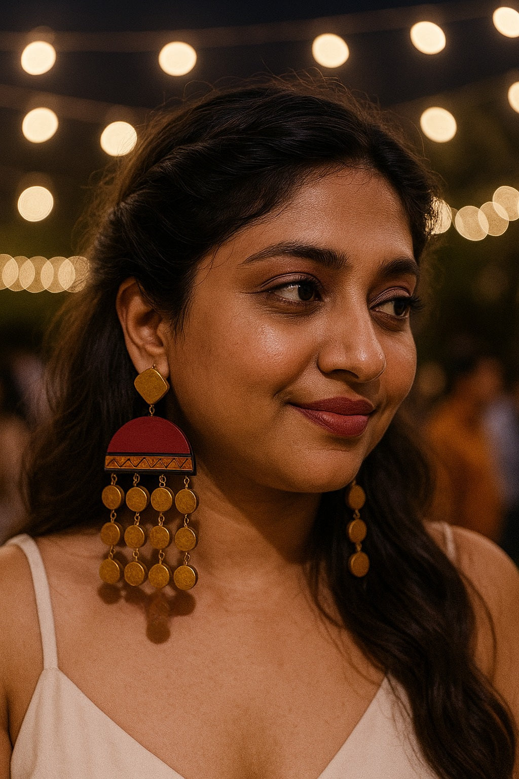 Woman wearing Ishani long earrings terracotta earrings by Anusangi Collections in outdoor evening setting